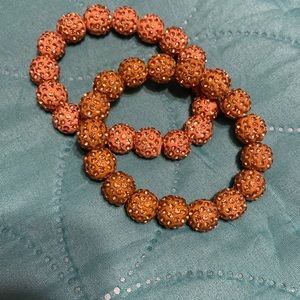 Set of 2 stretchy glitter ball bracelets one gold one rose gold